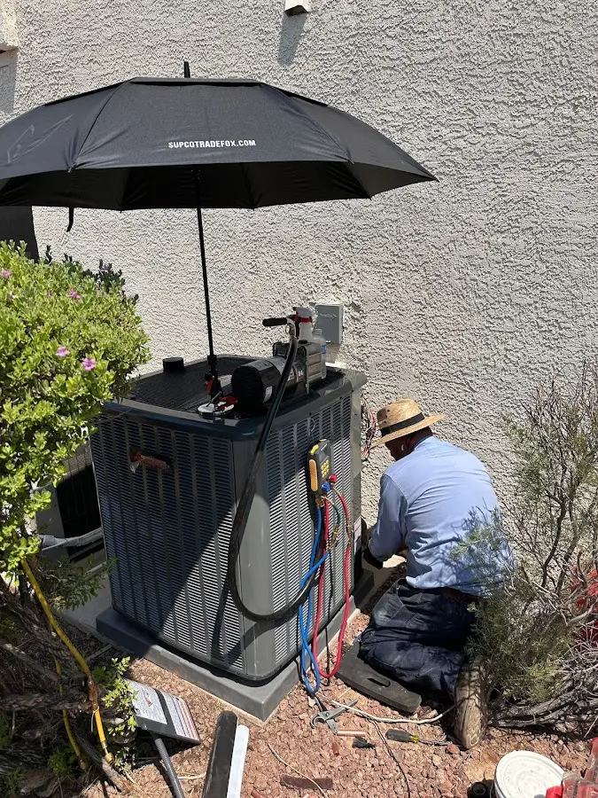 HVAC technician performing outdoor AC maintenance in Walnut
